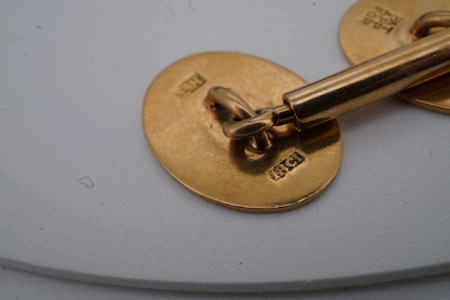 A pair of gold cuff-links, each end of oval outline with striped engraving, to a bar connector, each end 1.8cm, each stamped 18ct, combined gross weight approximately 9.5 grams, maker's marks EH, case stamped Jay's, Cond